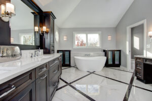 "Spathroom" remodel with soaking tub, dual vanity, white tile floors, dark cabinets, dual vanity.